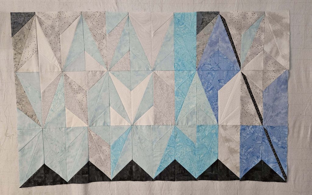 a quilt top that mimics the colors and textures of an iceberg